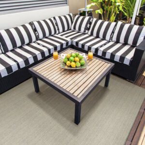 tan outdoor rug with stripped outdoor furniture
